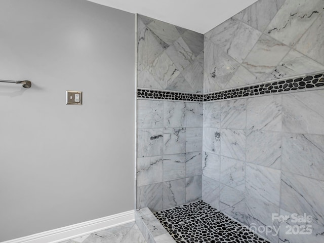 bathroom with a tile shower