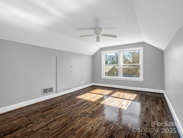 bonus room with lofted ceiling, dark wood-type flooring, and ceiling fan