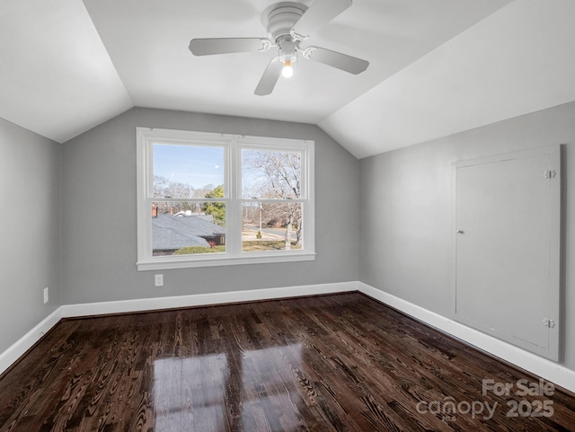 additional living space with lofted ceiling, dark hardwood / wood-style floors, and ceiling fan