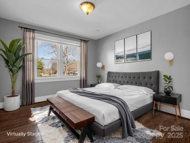 bedroom featuring baseboards and wood finished floors