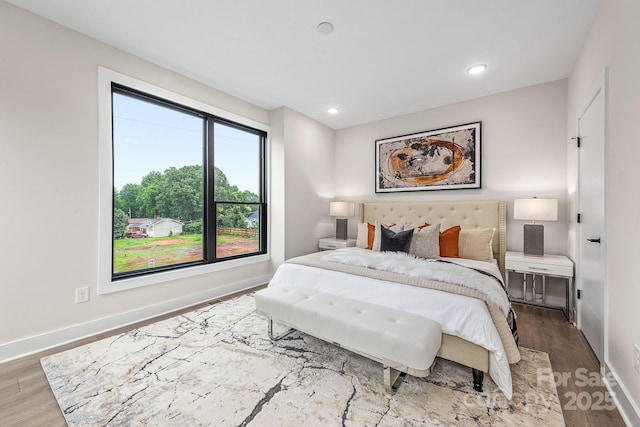 bedroom with hardwood / wood-style flooring