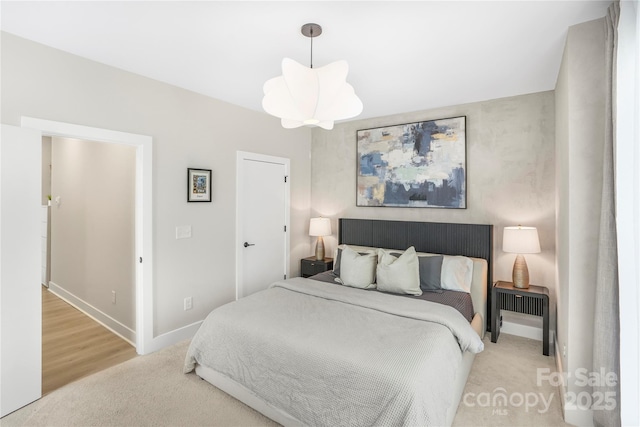 115 Verbena St NE Unit 12, Charlotte, NC 28217 - bedroom featuring light carpet and baseboards