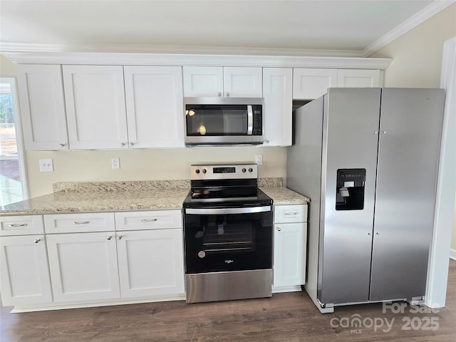 kitchen with dark wood-type flooring, ornamental molding, appliances with stainless steel finishes, light stone countertops, and white cabinets