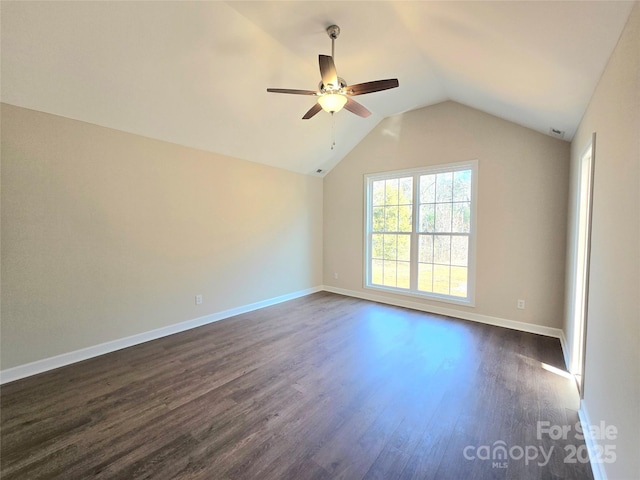 unfurnished room featuring lofted ceiling, dark hardwood / wood-style floors, and ceiling fan