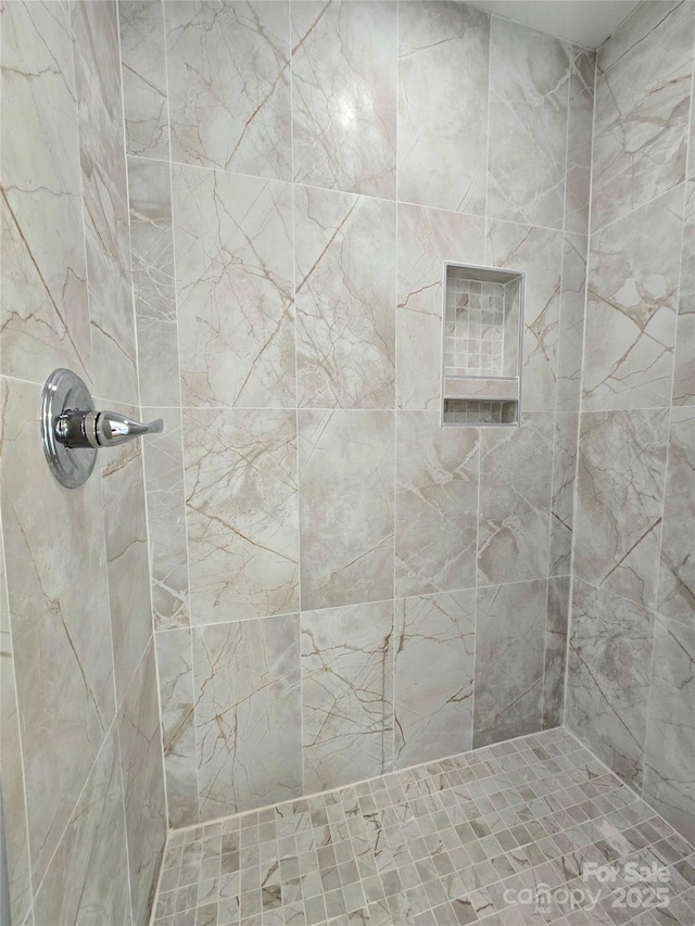 bathroom with tiled shower