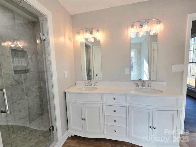 bathroom with vanity, a shower with shower door, and wood-type flooring