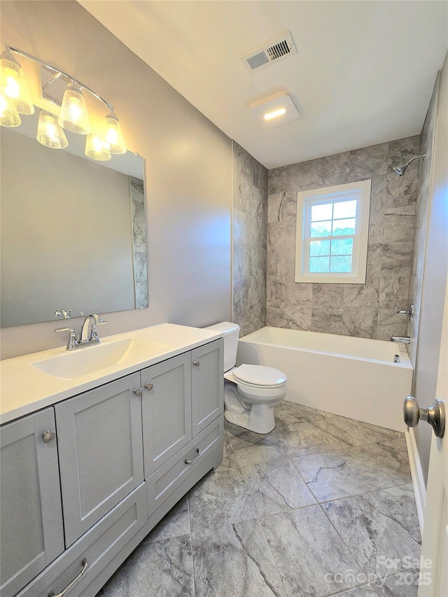 full bathroom featuring vanity, toilet, and tiled shower / bath