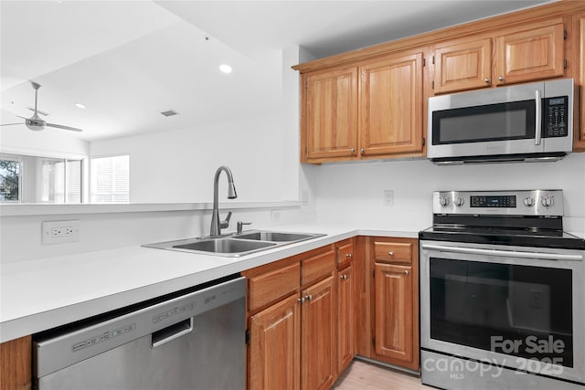 kitchen with stainless steel appliances, sink, and ceiling fan