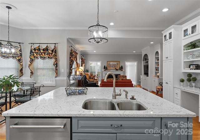 kitchen featuring gray cabinetry, sink, hanging light fixtures, and white cabinets