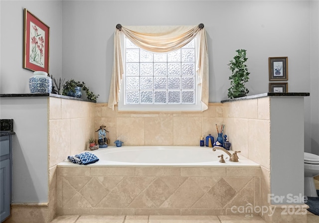 bathroom featuring vanity and tiled bath