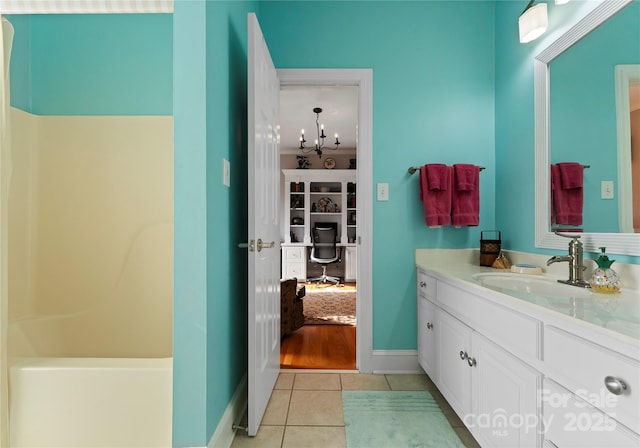 bathroom featuring vanity, a shower, and tile patterned floors