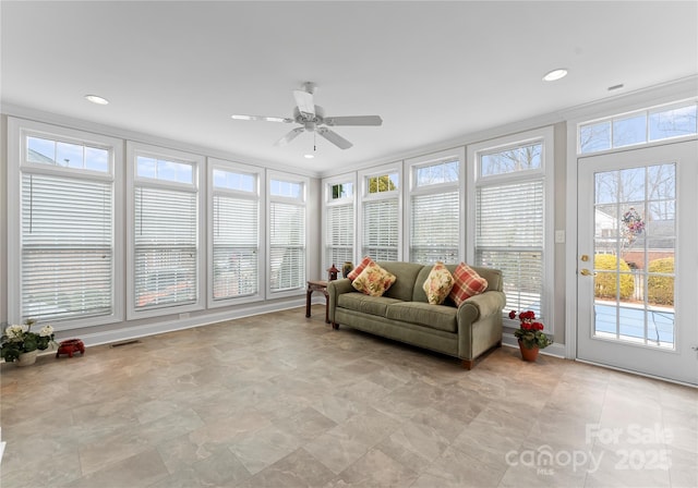 sunroom / solarium featuring ceiling fan