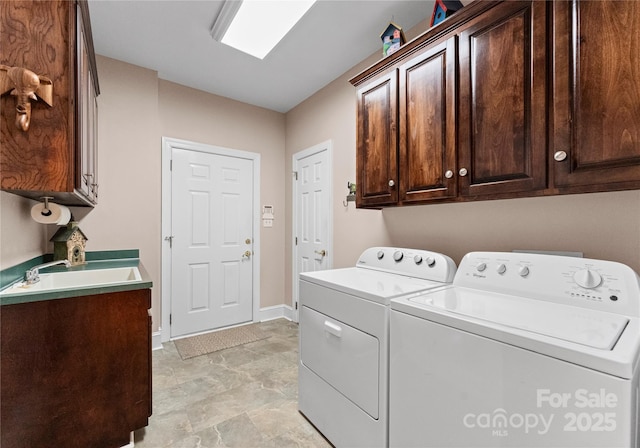 laundry area featuring cabinets, independent washer and dryer, and sink