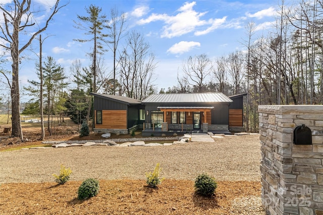 back of property featuring covered porch