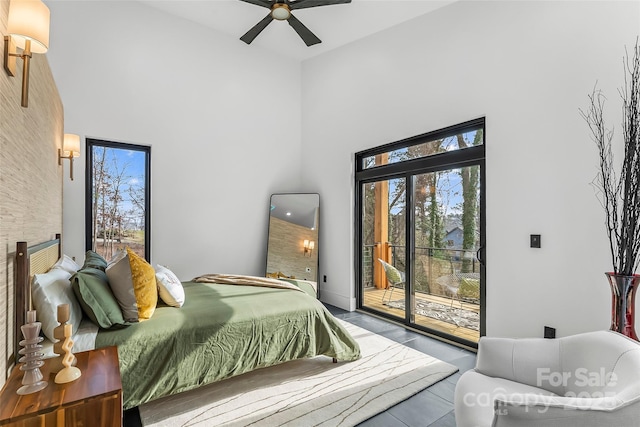 bedroom with access to exterior and a high ceiling