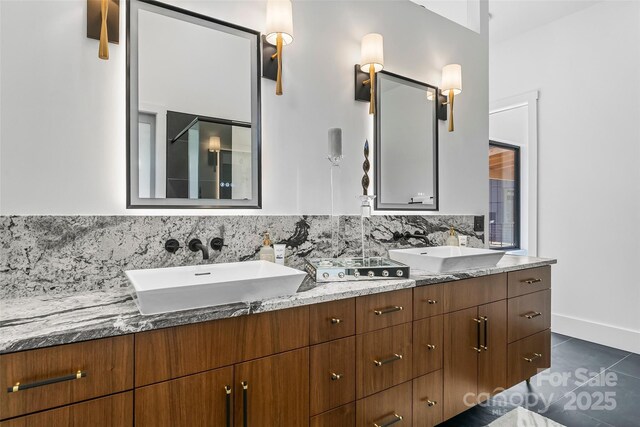 bathroom with tasteful backsplash, tile patterned floors, and vanity