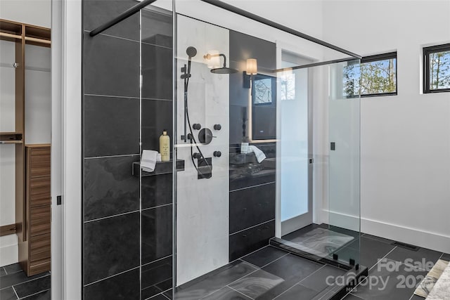 bathroom with walk in shower and tile patterned floors