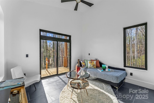 bedroom with ceiling fan, tile patterned flooring, and access to outside