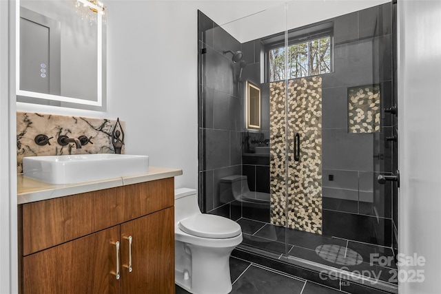 bathroom with a shower with door, vanity, tile patterned flooring, and toilet