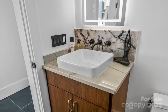 bathroom featuring tasteful backsplash and vanity