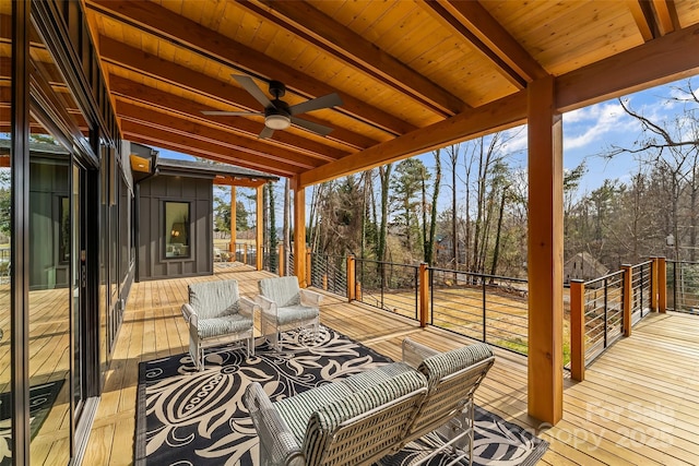 wooden deck with ceiling fan and an outdoor living space