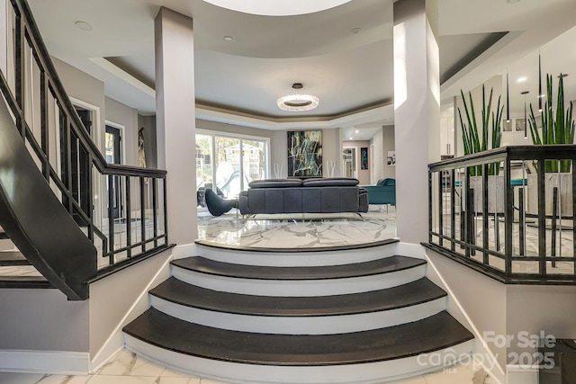 staircase with a raised ceiling