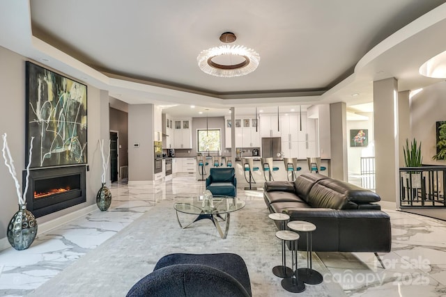 living room with a tray ceiling