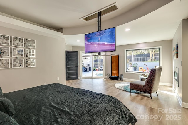 bedroom featuring multiple windows and light wood-type flooring