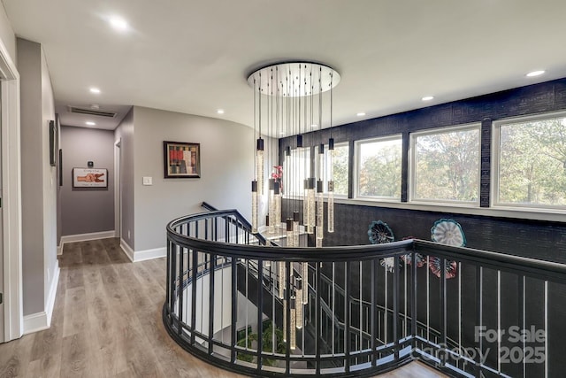 hall with hardwood / wood-style flooring and a healthy amount of sunlight