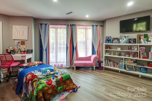 bedroom with wood-type flooring