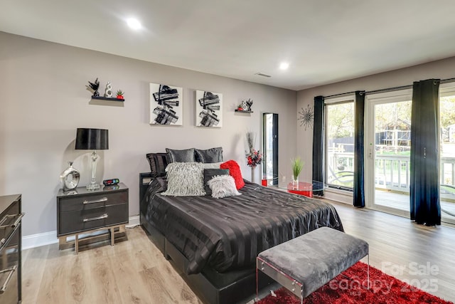 bedroom with access to outside and light hardwood / wood-style floors