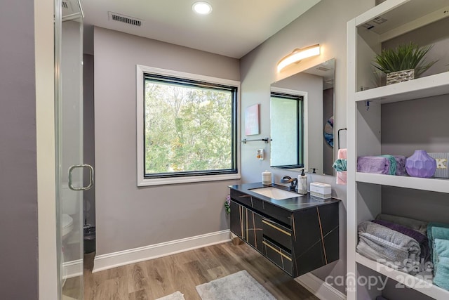 bathroom with vanity, hardwood / wood-style flooring, and toilet