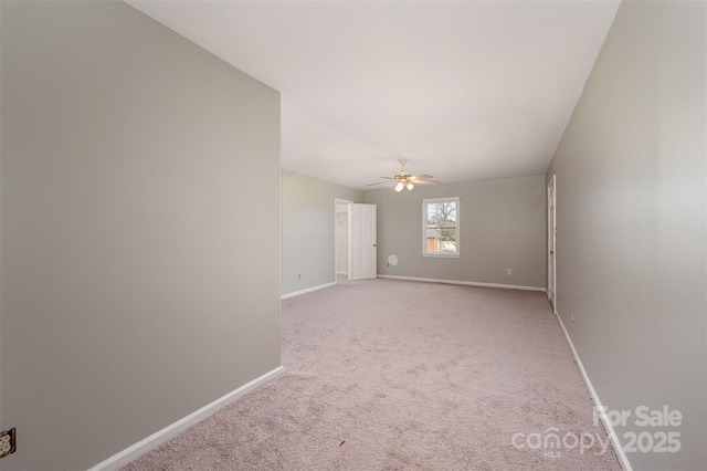 spare room featuring light carpet and ceiling fan