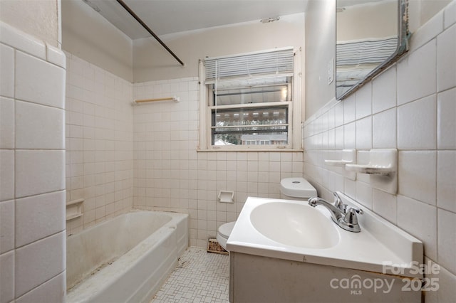 full bathroom featuring tile patterned floors, toilet, bathing tub / shower combination, tile walls, and vanity