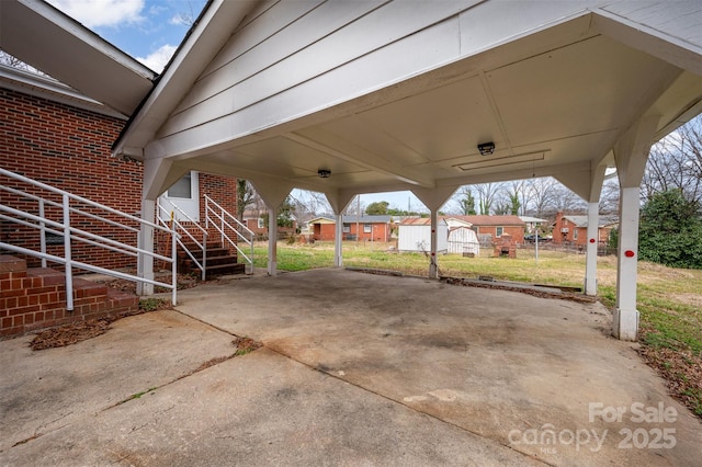 view of patio / terrace featuring a carport and a shed