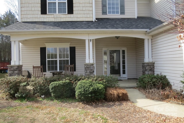 view of exterior entry with covered porch