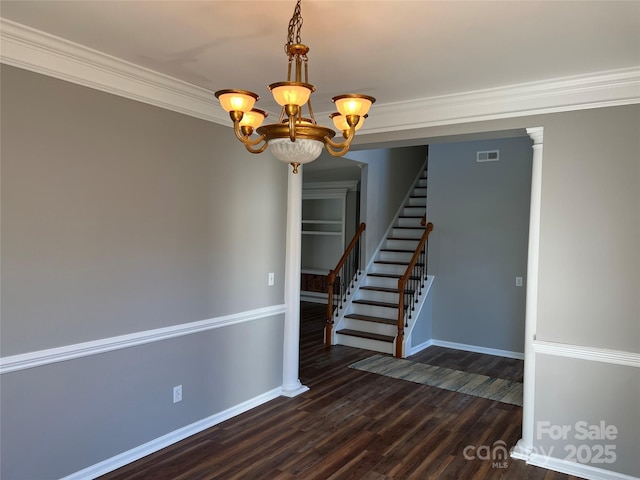 empty room with stairs, dark wood-type flooring, baseboards, and a notable chandelier