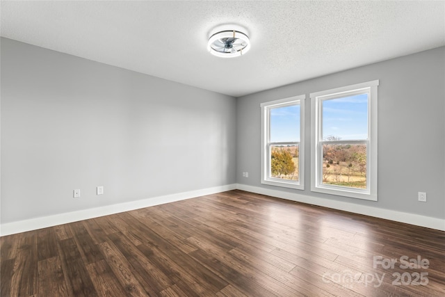 unfurnished room featuring hardwood / wood-style flooring and a textured ceiling