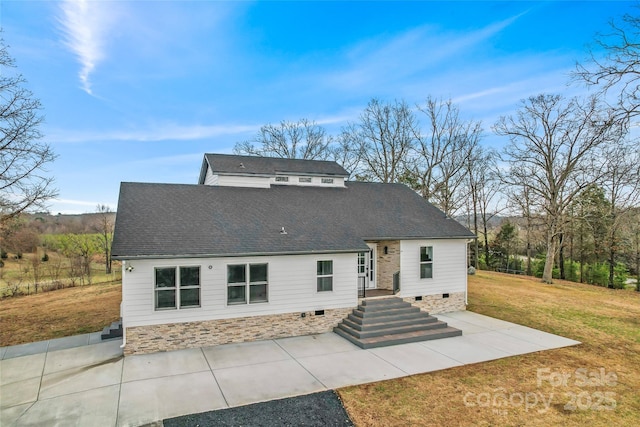 rear view of property with a patio and a lawn