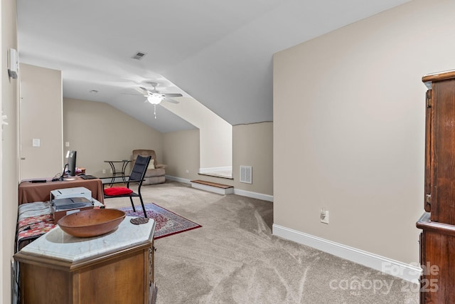 carpeted office with vaulted ceiling and ceiling fan