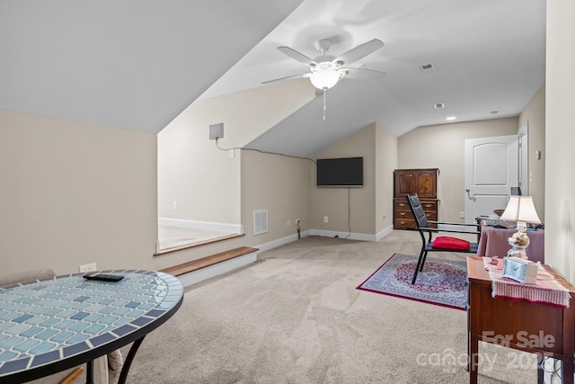 interior space with lofted ceiling, light colored carpet, and ceiling fan