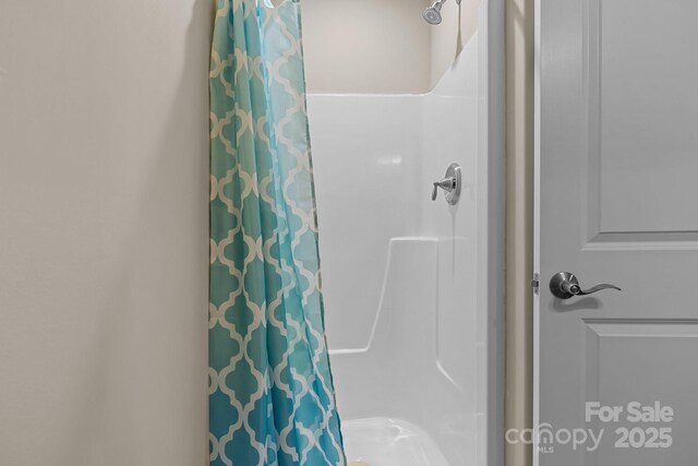 bathroom with a shower with shower curtain