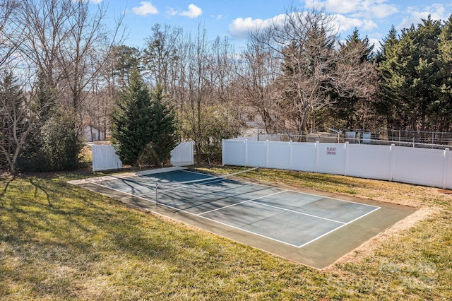 view of basketball court with a yard