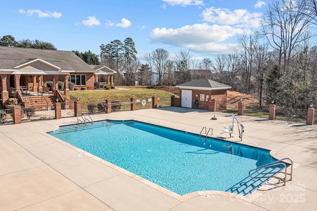 view of swimming pool featuring a fireplace and a patio