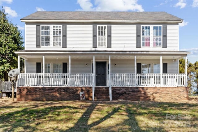 view of front facade featuring covered porch and a front lawn