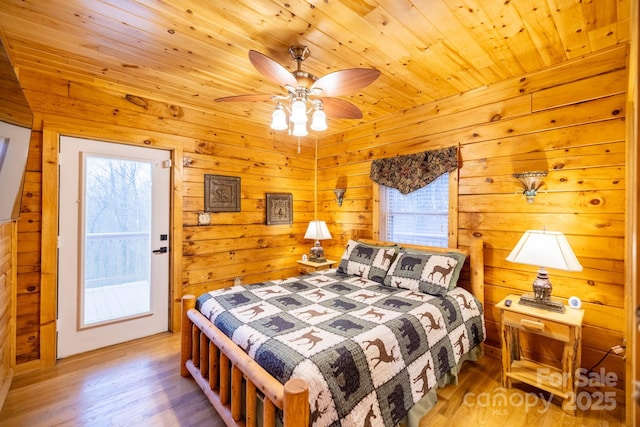 bedroom with multiple windows, wood-type flooring, and wooden ceiling