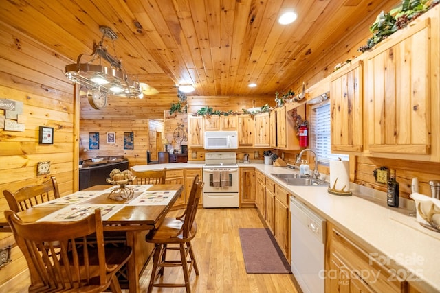 kitchen with pendant lighting, sink, wood ceiling, light hardwood / wood-style floors, and white appliances