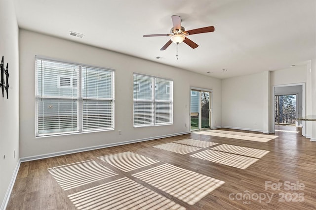 spare room featuring hardwood / wood-style floors and ceiling fan