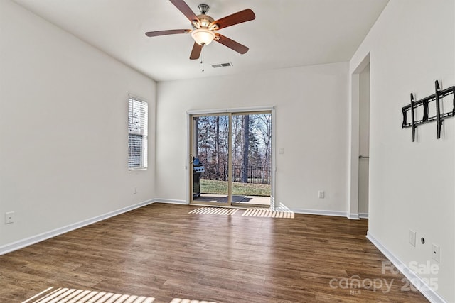 unfurnished room with dark hardwood / wood-style floors and ceiling fan