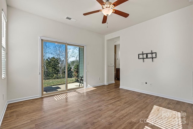 empty room featuring hardwood / wood-style flooring and ceiling fan